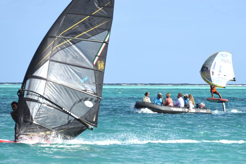 King Willem-Alexander, Queen Máxima and the Princess of Orange watch a windsurfing demonstration in Sorobon Bay