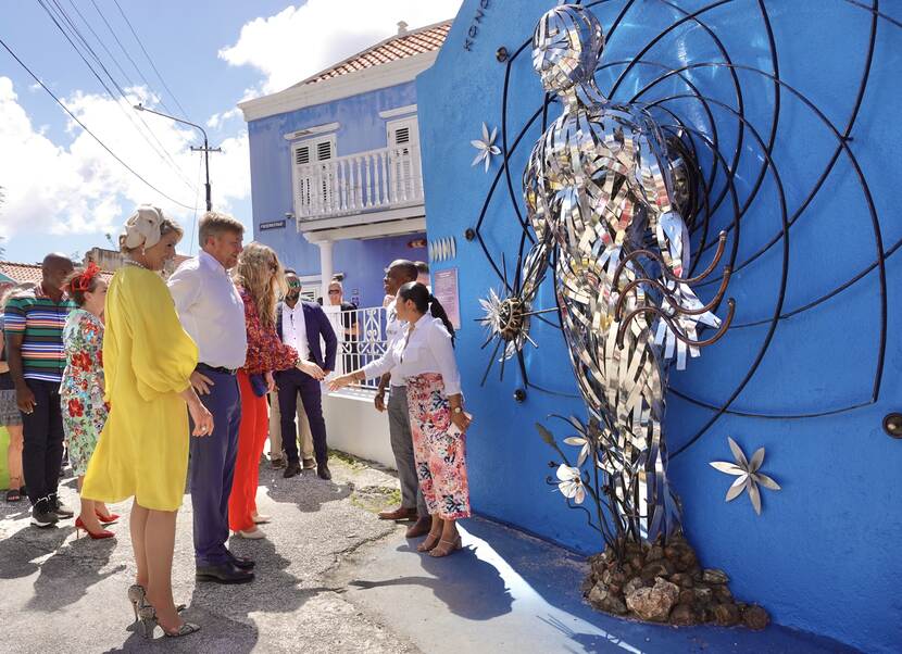 King Willem-Alexander, Queen Máxima and the Princess of Orange talk to residents and artists in Otrobanda in Curacao